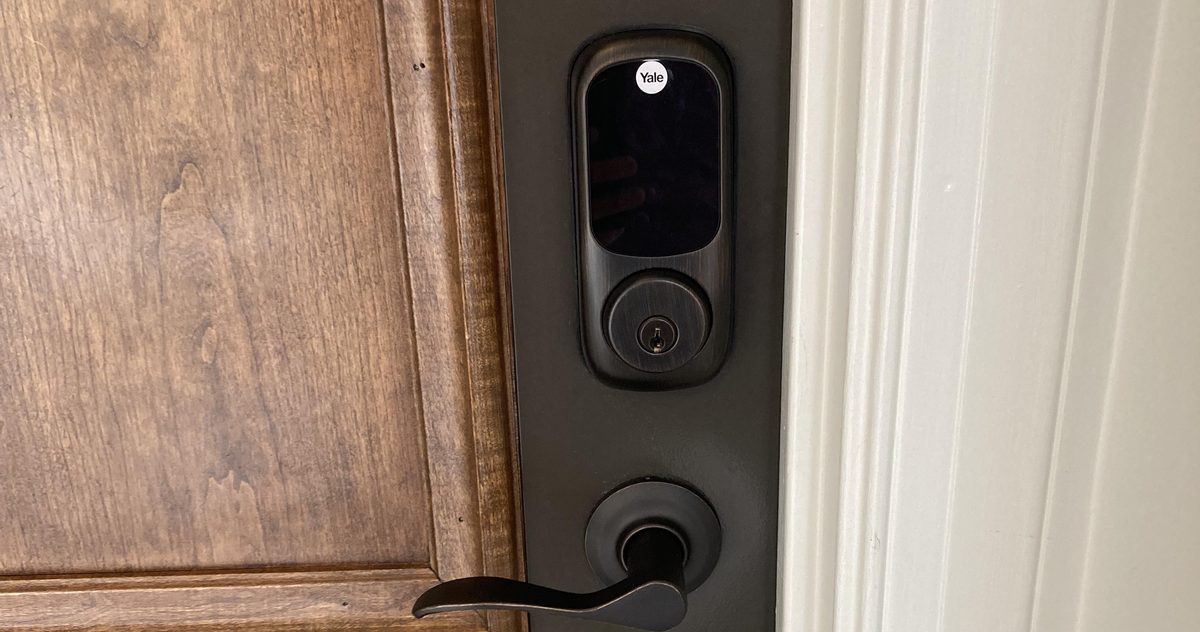 Property manager reviewing building lock hardware with a locksmith