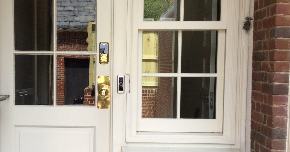 Residential locksmith installing a deadbolt on a front door